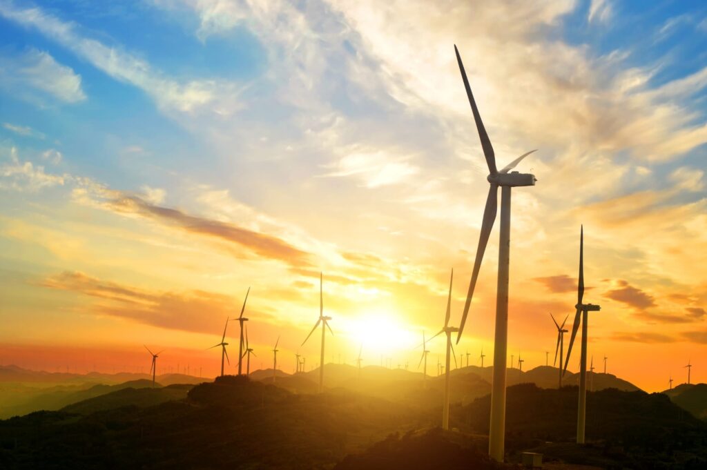 Sunny landscape with wind turbines.